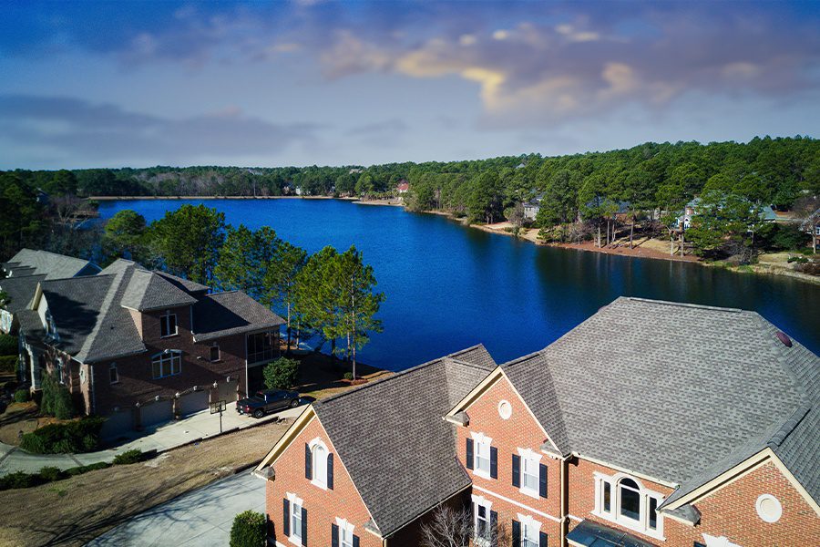 Boone, NC - Aerial View of Large North Carolina Homes by the Lake in the Evening