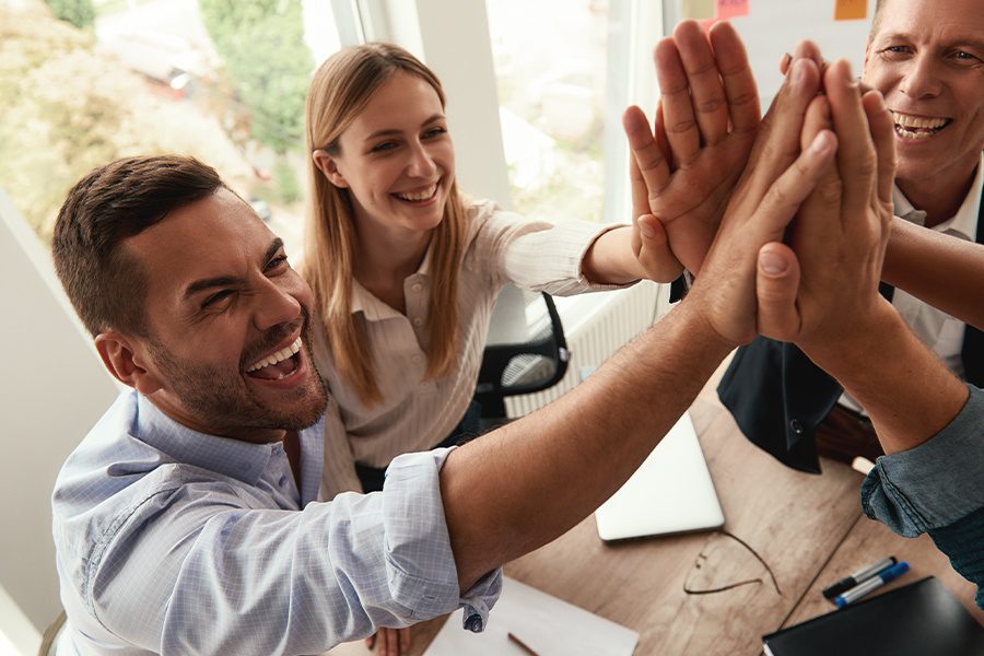 History of Granite - Successful Business Team Giving Each Other High-five and Smiling While Working Together in the Office