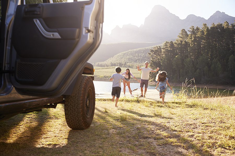 Personal Insurance - Excited Family Leaving Car Door Open While Running Toward Lake On a Road Trip in North Carolina