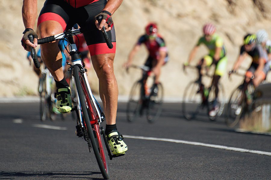 Amateur & Professional Sports Insurance - Closeup Athletes Riding a Race in a Cycling Competition