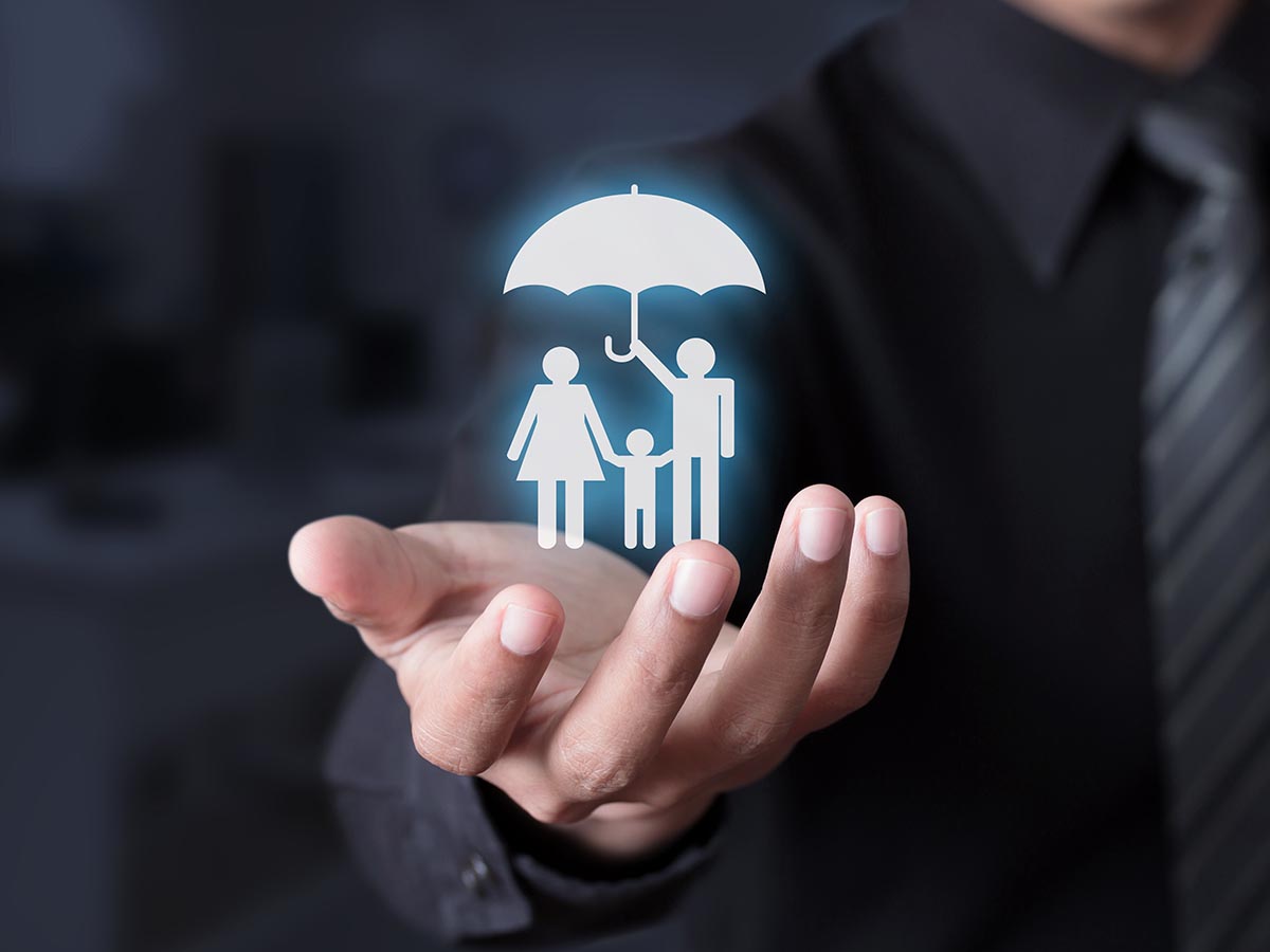 Silhouette of family under an umbrella in a man's hand