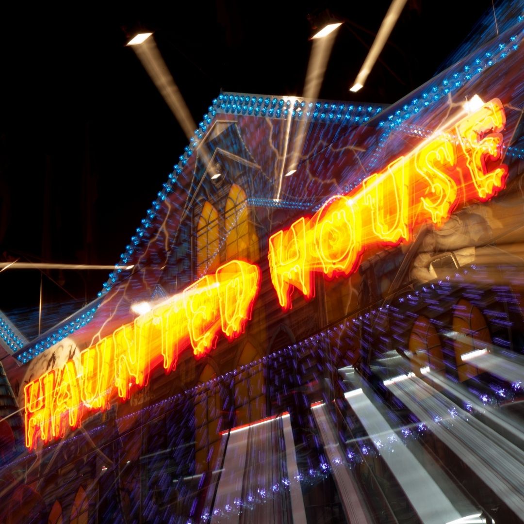 Imag eof a haunted house entrance with neon sign