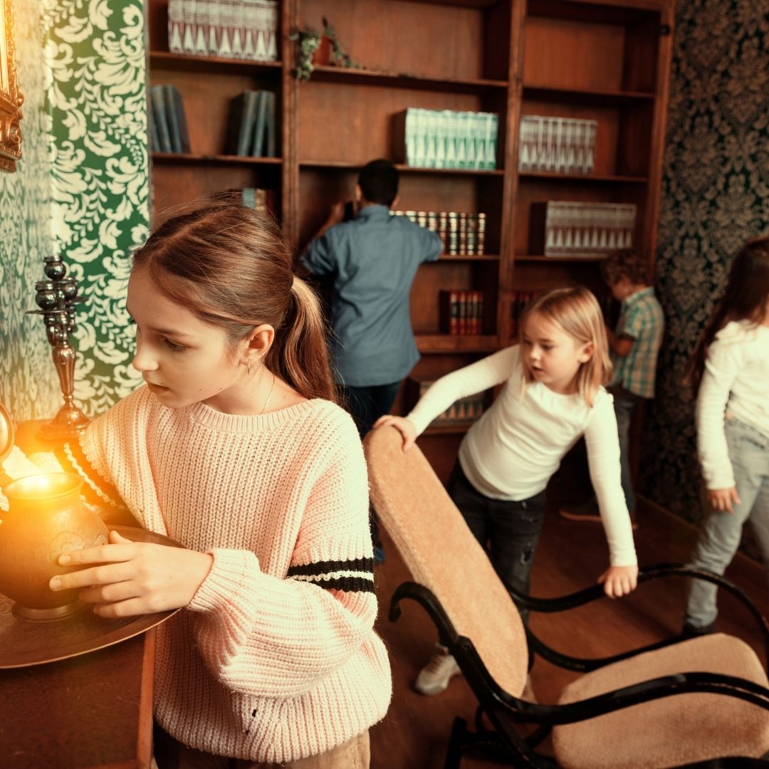 family having fun while playing an escape room attraction