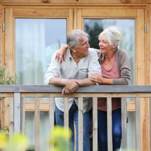 Senior couple on balcony of cabin