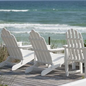 Beach chairs on wood deck near the ocean