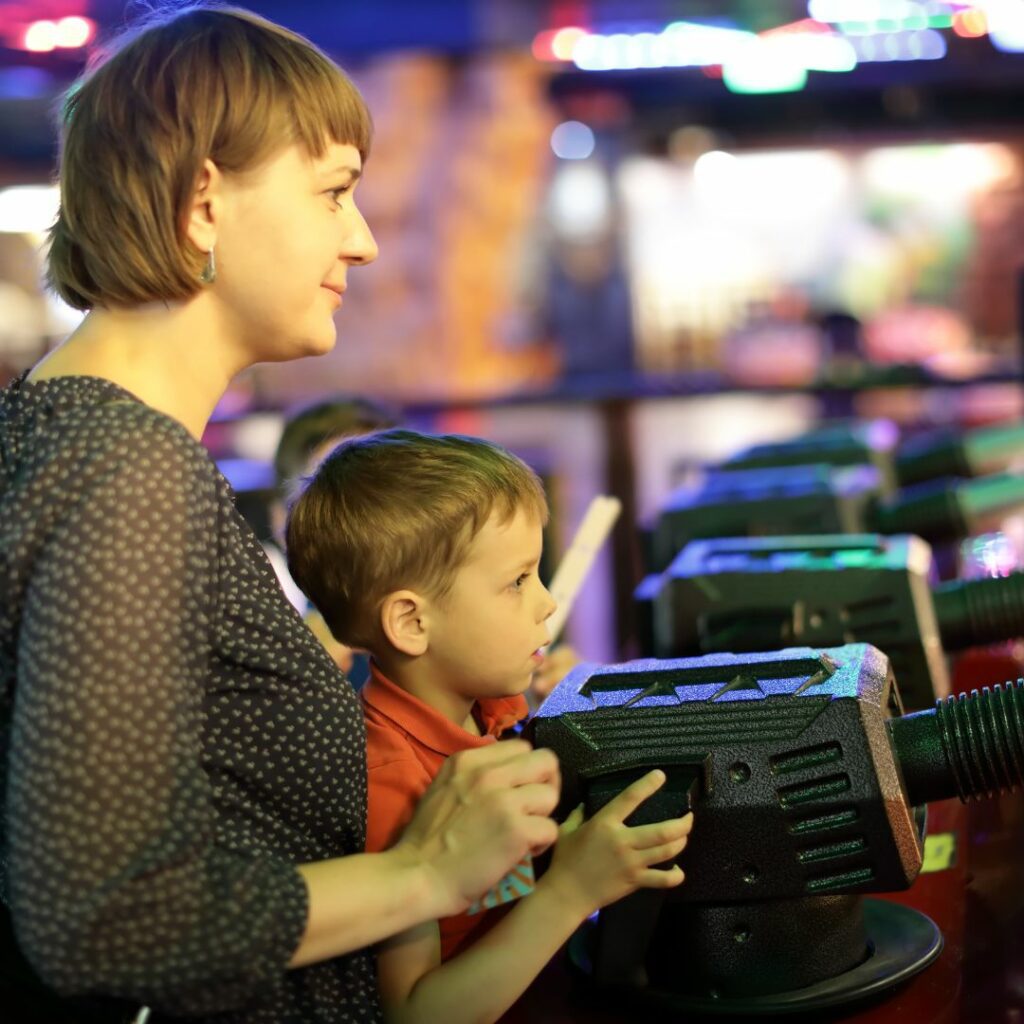 MOm and son playing arcade game