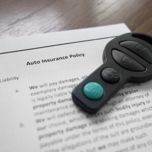 auto insurance policy with keys on top