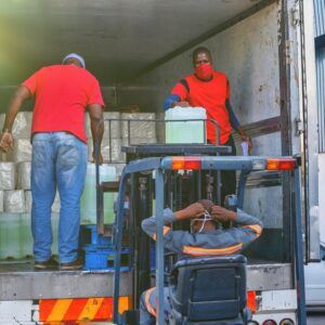 men loading truck with liquid containers